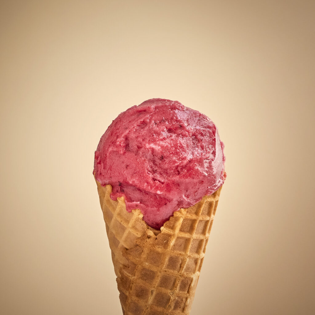scoop of blackberry lavender sorbet on a waffle cone