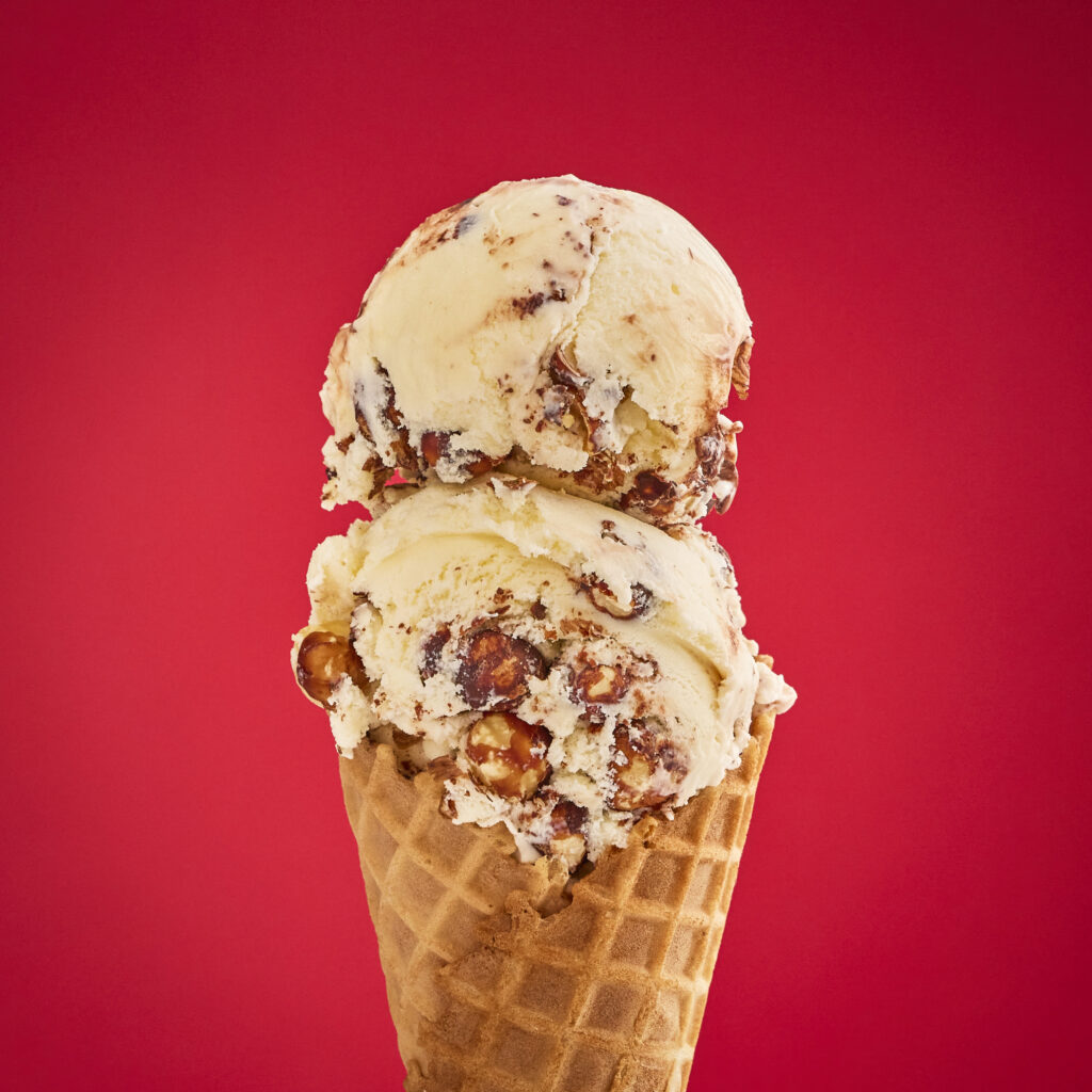 Double scoop of coffee ice cream with fudge swirl and hazelnuts