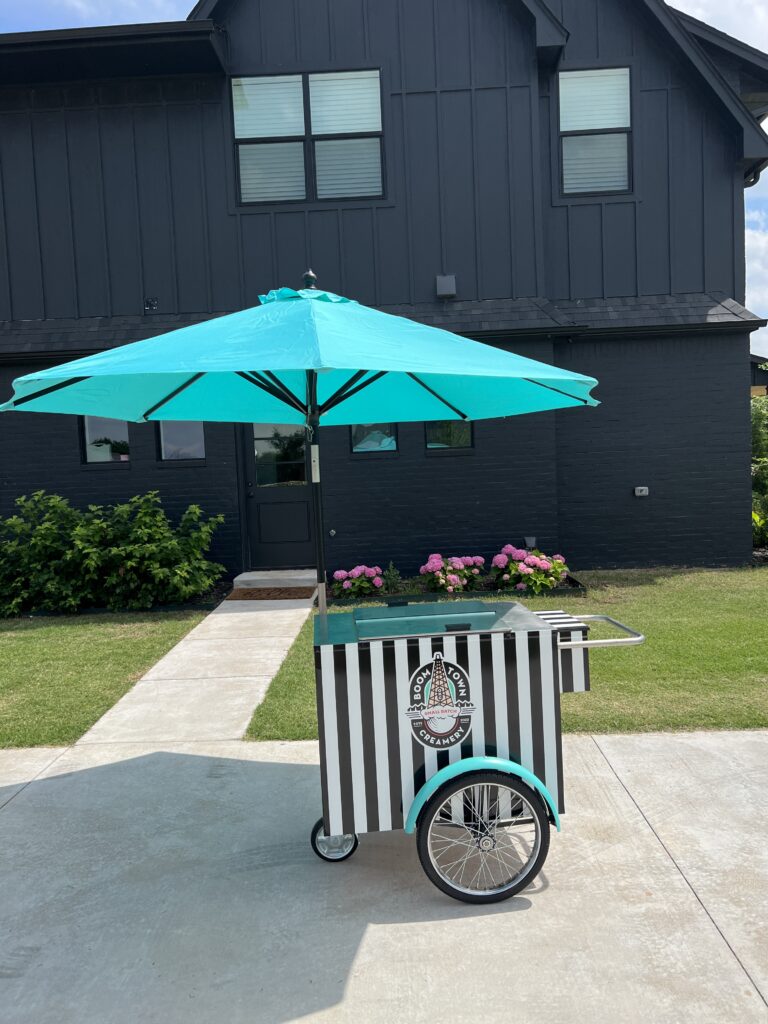 Boom Town Creamery's mobile ice cream cart with umbrella